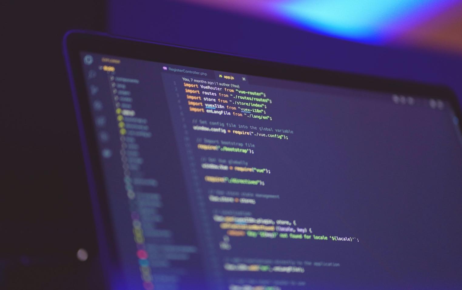 Database development workspace with multiple monitors showing code and database schemas